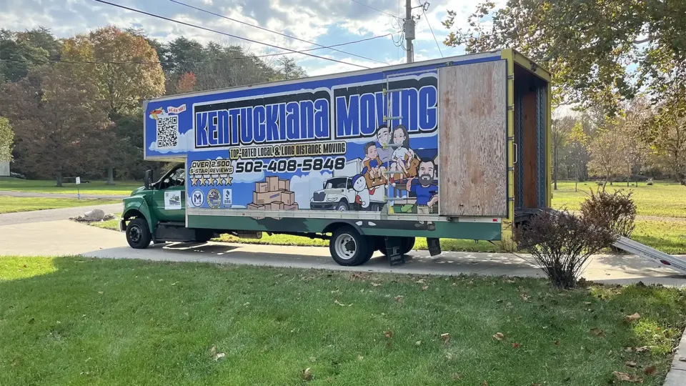 Kentuckiana Moving branded truck parked at a home