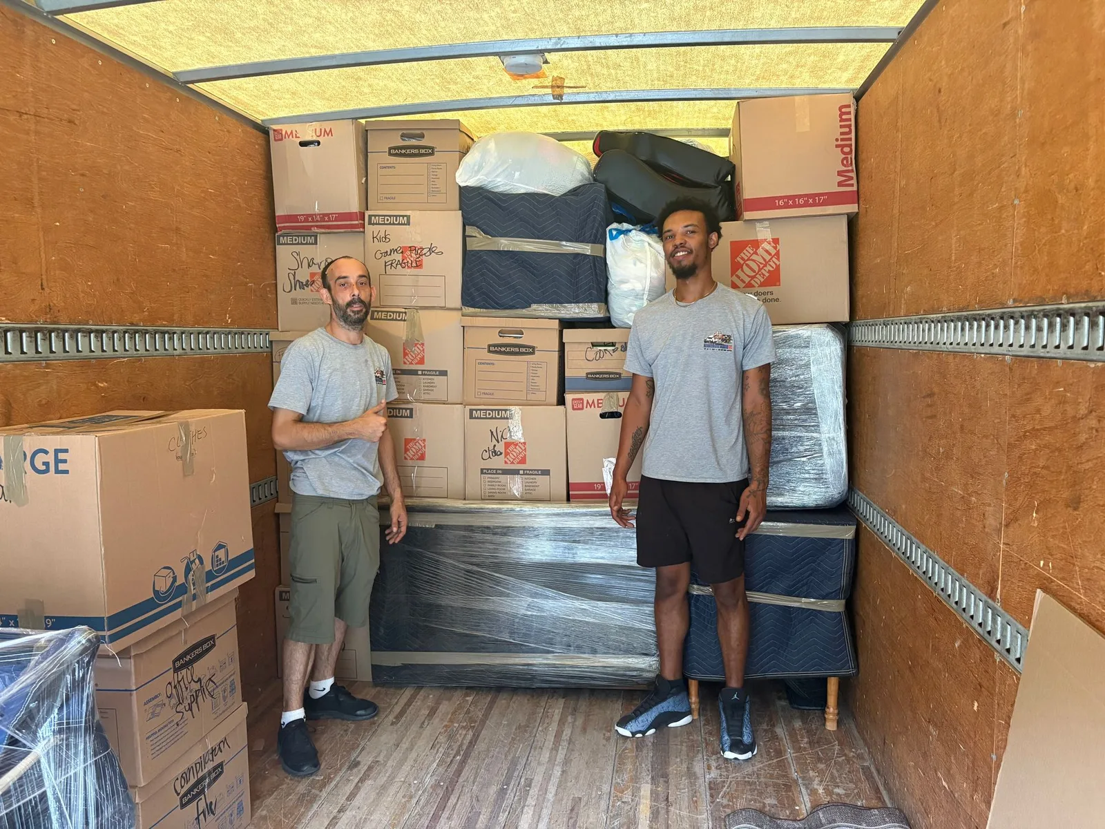 Kentuckiana movers standing with a fully loaded moving truck
