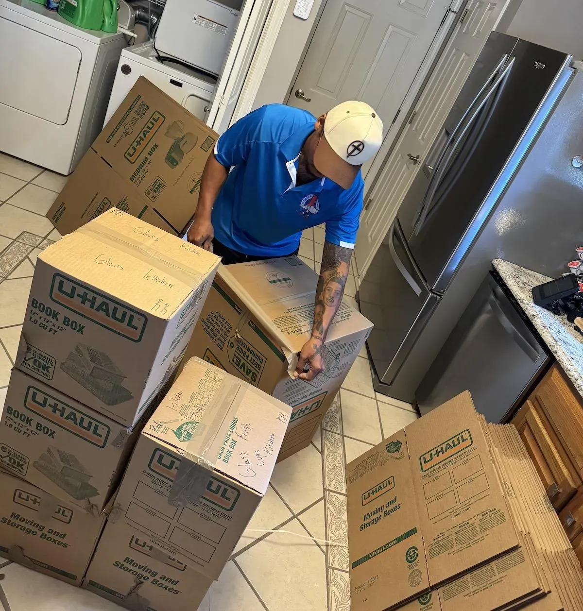 Kentuckiana mover labeling packed boxes in a kitchen